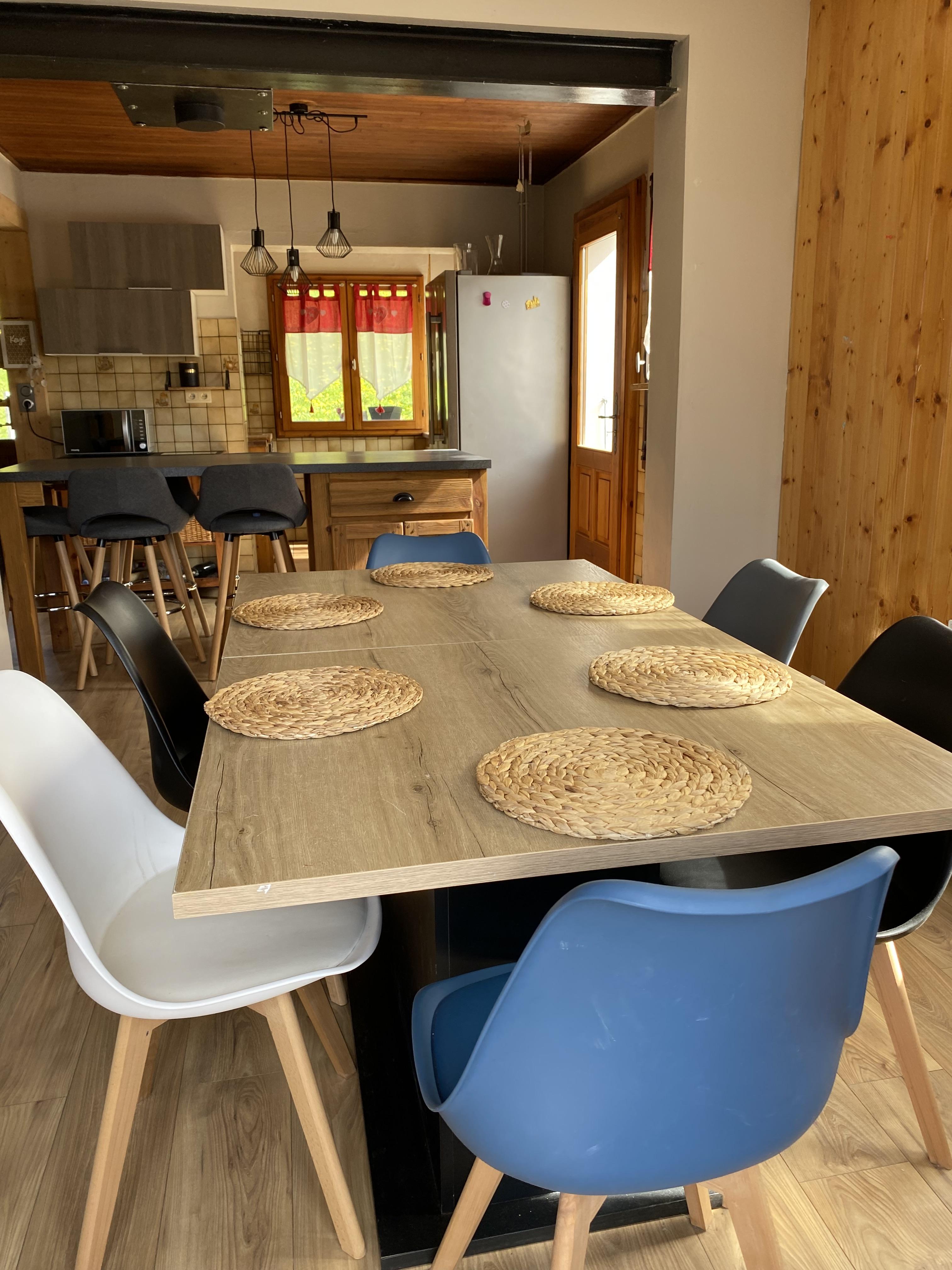 Salle à manger avec en arrière plan la cuisine