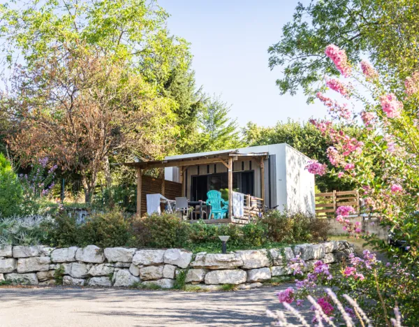 mobilhome entouré de verdure et de fleurs